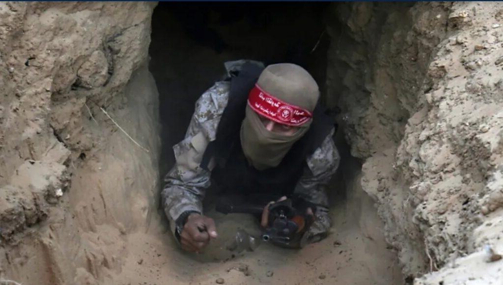 A Hamas fighter emerging from a Gaza tunnel.